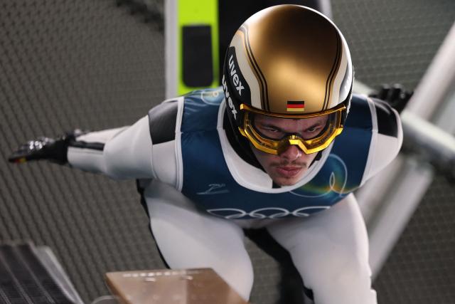 Germany's Philipp Raimund prepares prior to jumping during the trial round of the men's large hill super team ski jumping of the Milano Cortina 2026 Winter Olympic Games at Predazzo Ski Jumping Stadium in Predazzo (Val di Fiemme), on February 16, 2026. (Photo by Anne-Christine POUJOULAT / AFP)