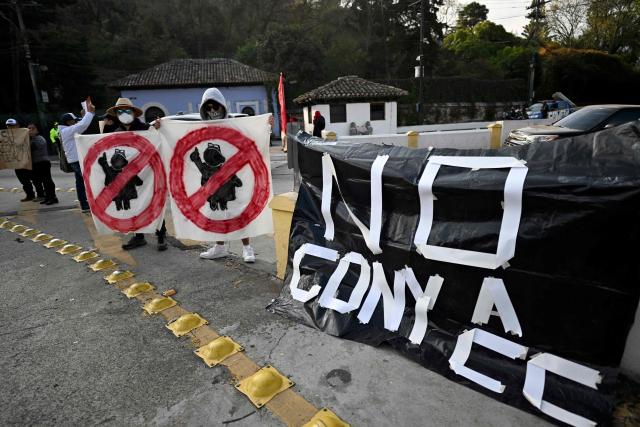 University students and members of civil society demonstrate outside a hotel as University of San Carlos officials meet to appoint Constitutional Court magistrates, protesting the possible selection of Attorney General Consuelo Porras, in Antigua, Guatemala, on February 16, 2026. Guatemala has begun the process to renew members of key judicial institutions, including its top court and the Prosecutor's Office, which for years have been suspected of protecting a network of corruption and criminal activity. (Photo by JOHAN ORDONEZ / AFP)