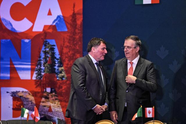 Canada's Minister of Internal Trade, Dominic LeBlanc (L), listens to Mexico's Secretary of Economy, Marcelo Ebrard (R), during a meeting with Canadian business leaders in Mexico City on February 16, 2026. (Photo by Yuri CORTEZ / AFP)