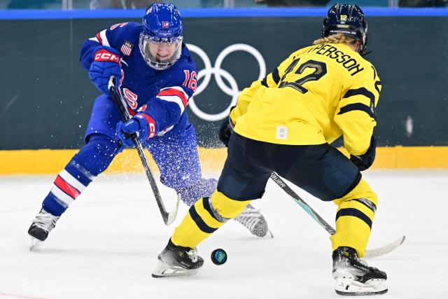 USA's forward #16 Hayley Scamurra (L) fights for the puck with Sweden's #12 Maja Nylen Persson during the women's play-off semi-final ice hockey match between USA and Sweden at the Milano Santagiulia Ice Hockey Arena during the Milano Cortina 2026 Winter Olympic Games in Milan, on February 16, 2026. (Photo by Piero CRUCIATTI / AFP)
