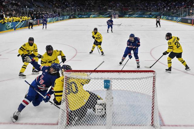 USA's forward #24 Joy Dunne (L) slips during the women's play-off semi-final ice hockey match between USA and Sweden at the Milano Santagiulia Ice Hockey Arena during the Milano Cortina 2026 Winter Olympic Games in Milan, on February 16, 2026. (Photo by Alexander NEMENOV / POOL / AFP)
