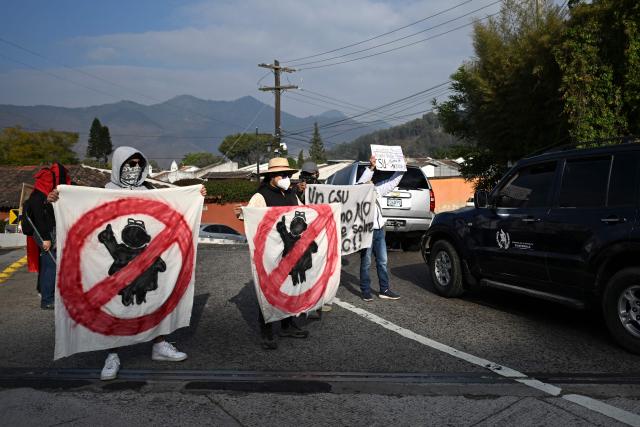 University students and members of civil society demonstrate outside a hotel as University of San Carlos officials meet to appoint Constitutional Court magistrates, protesting the possible selection of Attorney General Consuelo Porras, in Antigua, Guatemala, on February 16, 2026. Guatemala has begun the process to renew members of key judicial institutions, including its top court and the Prosecutor's Office, which for years have been suspected of protecting a network of corruption and criminal activity. (Photo by JOHAN ORDONEZ / AFP)