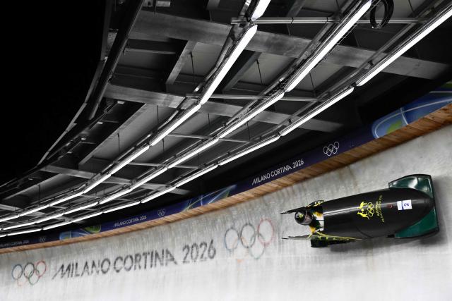 Australia's Bree Walker competes in the bobsleigh women's monobob heat 3 at Cortina Sliding Centre during the Milano Cortina 2026 Winter Olympic Games in Cortina d'Ampezzo on February 16, 2026. (Photo by Marco BERTORELLO / AFP)