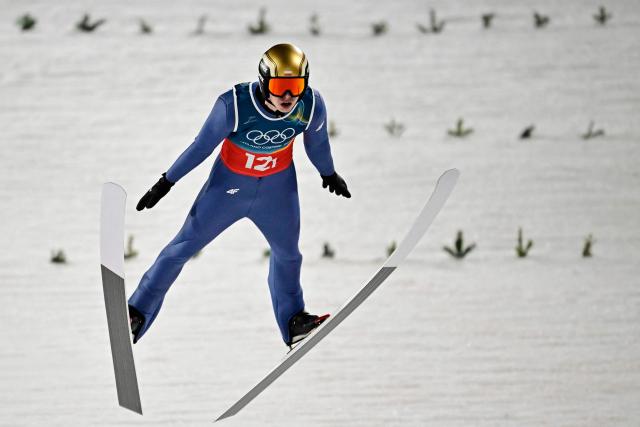 Poland's Pawel Wasek jumps during the 1st round of the men's large hill super team ski jumping of the Milano Cortina 2026 Winter Olympic Games at Predazzo Ski Jumping Stadium in Predazzo (Val di Fiemme), on February 16, 2026. (Photo by Tobias SCHWARZ / AFP)