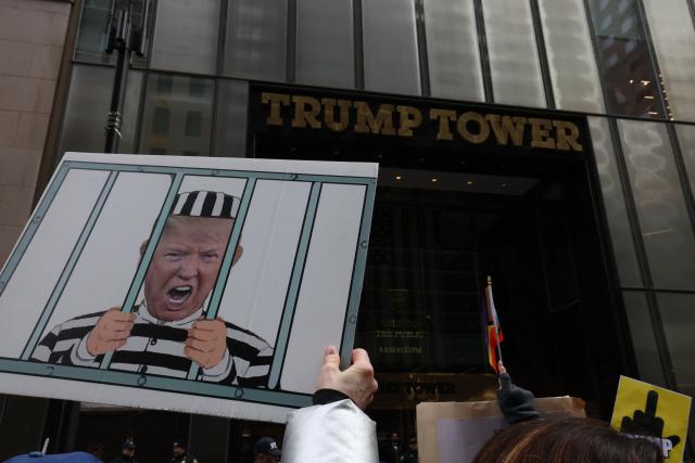 People gather during a flash-mob on President's Day in front of Trump Tower in New York, on February 16, 2026. (Photo by TIMOTHY A.CLARY / AFP)