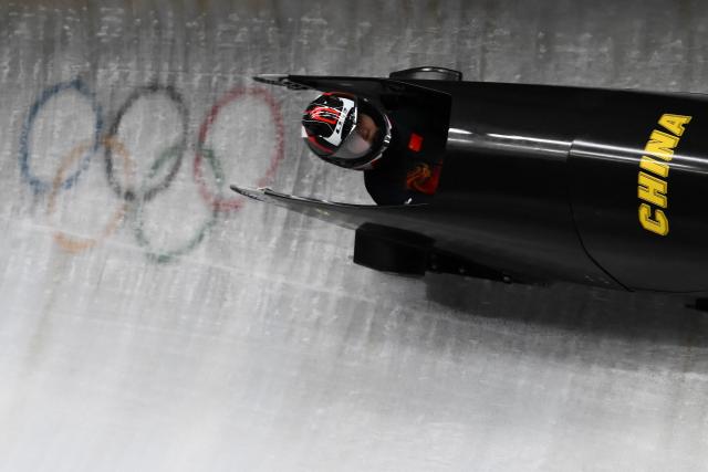 China's Huai Mingming competes in the bobsleigh women's monobob heat 3 at Cortina Sliding Centre during the Milano Cortina 2026 Winter Olympic Games in Cortina d'Ampezzo on February 16, 2026. (Photo by Marco BERTORELLO / AFP)