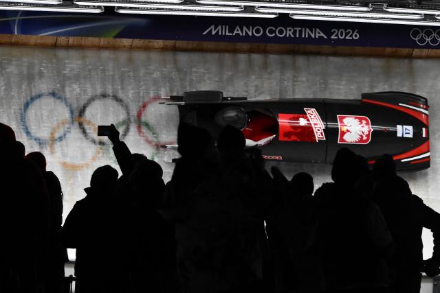 Poland's Linda Weiszewski competes in the bobsleigh women's monobob heat 3 at Cortina Sliding Centre during the Milano Cortina 2026 Winter Olympic Games in Cortina d'Ampezzo on February 16, 2026. (Photo by Marco BERTORELLO / AFP)