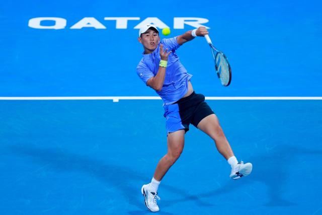 China's Shang Juncheng hits a return against Russia’s Daniil Medvedev during their men’s singles match at the Qatar Open tennis tournament in Doha on February 16, 2026. (Photo by Karim JAAFAR / AFP)