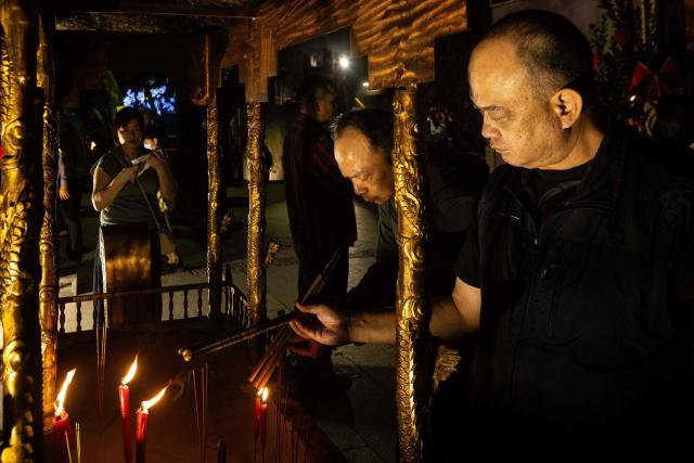 People burn incense at the A-Ma Temple during the start of celebrations of the Chinese Lunar New Year in Macau late February 16, 2026. (Photo by Eduardo Leal / AFP)