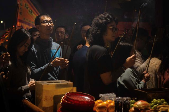People pray at the A-Ma Temple during the start of celebrations of the Chinese Lunar New Year in Macau late February 16, 2026. (Photo by Eduardo Leal / AFP)