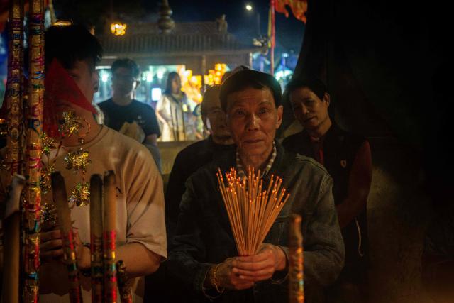 People pray at the A-Ma Temple during the start of celebrations of the Chinese Lunar New Year in Macau late February 16, 2026. (Photo by Eduardo Leal / AFP)