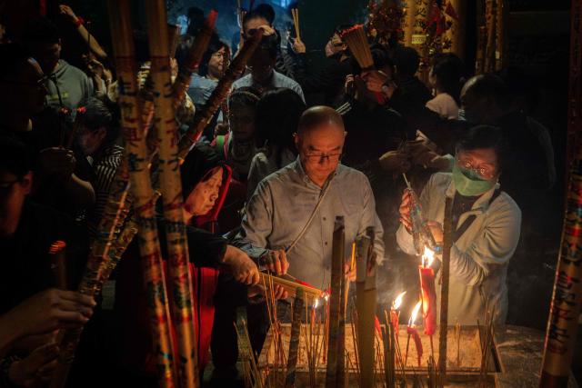 People burn incense at the A-Ma Temple during the start of celebrations of the Chinese Lunar New Year in Macau late February 16, 2026. (Photo by Eduardo Leal / AFP)