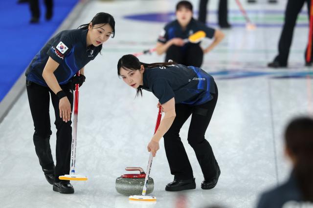 South Korea's Kim Suji (R) and South Korea's Seol Yeji compete in the curling women's round robin between South Korea and China during the Milano Cortina 2026 Winter Olympic Games at the Cortina Curling Olympic Stadium in Cortina d’Ampezzo on February 16, 2026. (Photo by Odd ANDERSEN / AFP)