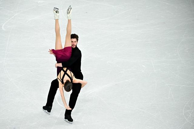 Poland's Ioulia Chtchetinina and Poland's Michal Wozniak compete in the figure skating pair skating free skating final during the Milano Cortina 2026 Winter Olympic Games at Milano Ice Skating Arena in Milan on February 16, 2026. (Photo by JULIEN DE ROSA / AFP)