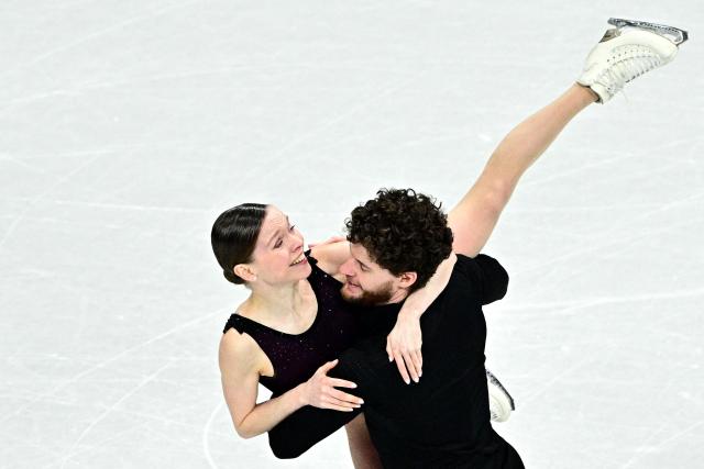 Poland's Ioulia Chtchetinina and Michal Wozniak compete in the figure skating pair skating free skating final during the Milano Cortina 2026 Winter Olympic Games at Milano Ice Skating Arena in Milan on February 16, 2026. (Photo by JULIEN DE ROSA / AFP)