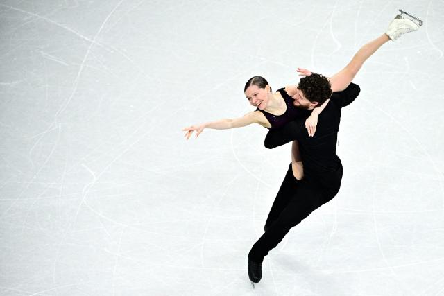 Poland's Ioulia Chtchetinina and Michal Wozniak compete in the figure skating pair skating free skating final during the Milano Cortina 2026 Winter Olympic Games at Milano Ice Skating Arena in Milan on February 16, 2026. (Photo by JULIEN DE ROSA / AFP)