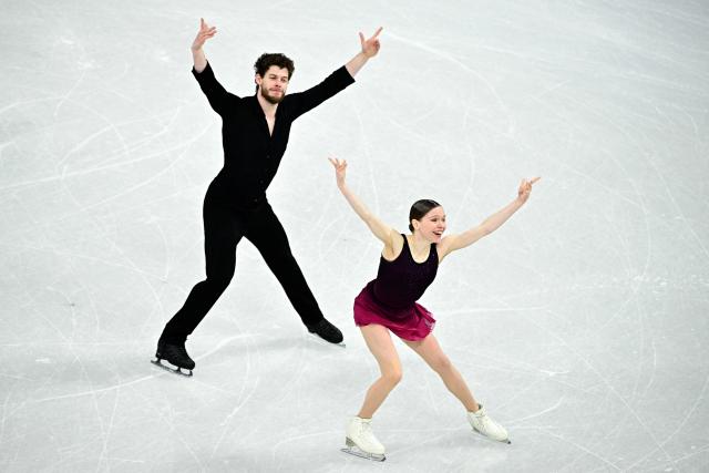 Poland's Ioulia Chtchetinina and Poland's Michal Wozniak compete in the figure skating pair skating free skating final during the Milano Cortina 2026 Winter Olympic Games at Milano Ice Skating Arena in Milan on February 16, 2026. (Photo by JULIEN DE ROSA / AFP)