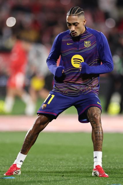 Barcelona's Brazilian forward #11 Raphinha warms up ahead of the Spanish league football match between Girona FC and FC Barcelona at Montilivi Stadium in Girona on February 16, 2026. (Photo by Josep LAGO / AFP)