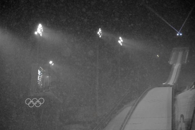 This photograph shows a view of the slope under snowfall during the final round of the men's large hill super team ski jumping of the Milano Cortina 2026 Winter Olympic Games at Predazzo Ski Jumping Stadium in Predazzo (Val di Fiemme), on February 16, 2026. (Photo by Tobias SCHWARZ / AFP)