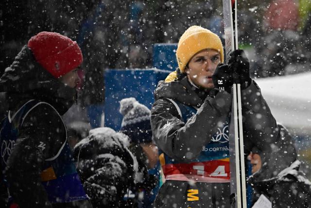 Germany's Philipp Raimund (L) and Germany's Andreas Wellinger react during the final round of the men's large hill super team ski jumping of the Milano Cortina 2026 Winter Olympic Games at Predazzo Ski Jumping Stadium in Predazzo (Val di Fiemme), on February 16, 2026. (Photo by Tobias SCHWARZ / AFP)