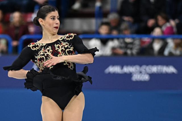 Italy's Rebecca Ghilardi and Italy's Filippo Ambrosini (out of frame) compete in the figure skating pair skating free skating final during the Milano Cortina 2026 Winter Olympic Games at Milano Ice Skating Arena in Milan on February 16, 2026. (Photo by Gabriel BOUYS / AFP)