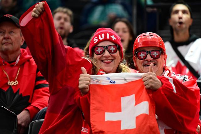 Switzerland's supporters cheer during the women's play-off semi-final ice hockey match between Canada and Switzerland at the Milano Santagiulia Ice Hockey Arena during the Milano Cortina 2026 Winter Olympic Games in Milan, on February 16, 2026. (Photo by Piero CRUCIATTI / AFP)