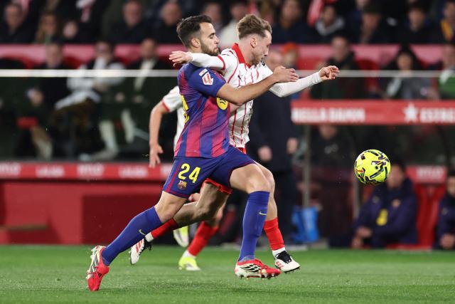 Barcelona's Spanish defender #24 Eric Garcia and Girona's Ukrainian forward #19 Vladyslav Vanat fight for the ball during the Spanish league football match between Girona FC and FC Barcelona at Montilivi Stadium in Girona on February 16, 2026. (Photo by Josep LAGO / AFP)