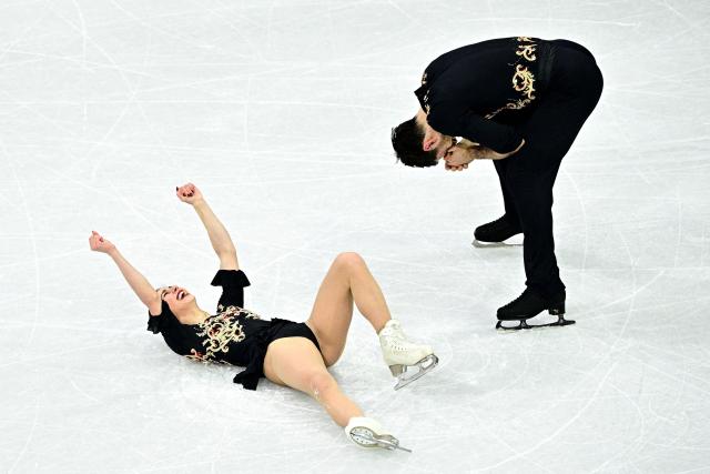 Italy's Rebecca Ghilardi and Filippo Ambrosini react after competing in the figure skating pair skating free skating final during the Milano Cortina 2026 Winter Olympic Games at Milano Ice Skating Arena in Milan on February 16, 2026. (Photo by JULIEN DE ROSA / AFP)