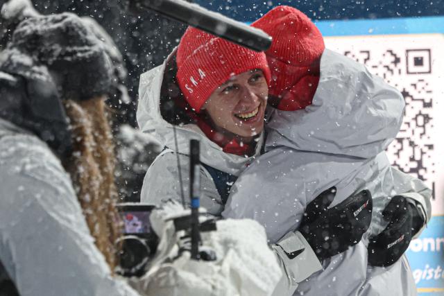 Poland's Pawel Wasek (L) reacts with Poland's Kacper Tomasiak after jumping during the final round of the men's large hill super team ski jumping of the Milano Cortina 2026 Winter Olympic Games at Predazzo Ski Jumping Stadium in Predazzo (Val di Fiemme), on February 16, 2026. (Photo by Anne-Christine POUJOULAT / AFP)