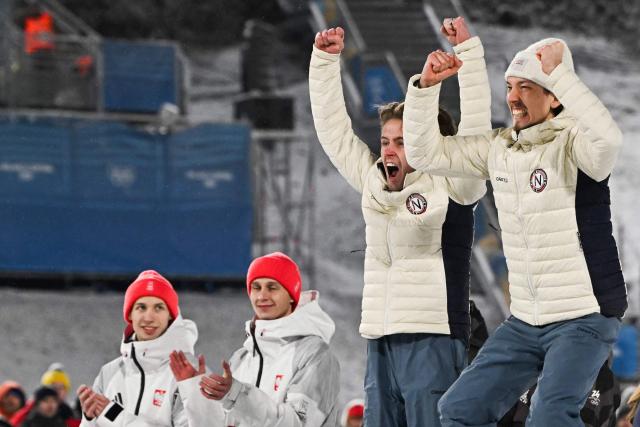 (fromL) Silver medallists Poland's Kacper Tomasiak, Poland's Pawel Wasek and bronze medallists Norway's Kristoffer Eriksen Sundal and Norway's Johann Andre Forfang celebrate on the podium for the men's large hill super team ski jumping of the Milano Cortina 2026 Winter Olympic Games at Predazzo Ski Jumping Stadium in Predazzo (Val di Fiemme), on February 16, 2026. (Photo by Javier SORIANO / AFP)
