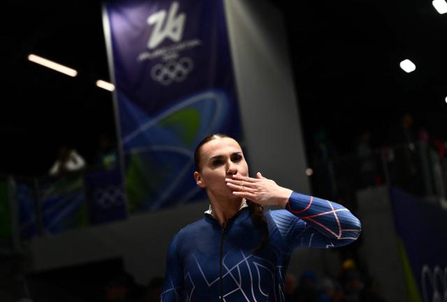 Britain's Adele Nicoll blows a kiss to the crowd after competing in the bobsleigh women's monobob heat 4 at Cortina Sliding Centre during the Milano Cortina 2026 Winter Olympic Games in Cortina d'Ampezzo on February 16, 2026. (Photo by Marco BERTORELLO / AFP)