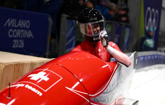 Switzerland's Melanie Hasler reacts after competing in the bobsleigh women's monobob heat 4 at Cortina Sliding Centre during the Milano Cortina 2026 Winter Olympic Games in Cortina d'Ampezzo on February 16, 2026. (Photo by Marco BERTORELLO / AFP)