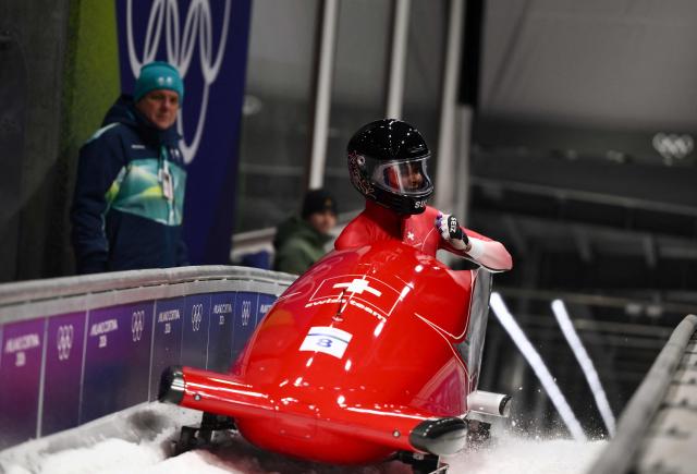 Switzerland's Melanie Hasler reacts after competing in the bobsleigh women's monobob heat 4 at Cortina Sliding Centre during the Milano Cortina 2026 Winter Olympic Games in Cortina d'Ampezzo on February 16, 2026. (Photo by Marco BERTORELLO / AFP)