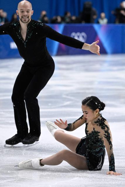 USA's Ellie Kam falls as she and USA's Danny O'Shea compete in the figure skating pair skating free skating final during the Milano Cortina 2026 Winter Olympic Games at Milano Ice Skating Arena in Milan on February 16, 2026. (Photo by WANG Zhao / AFP)
