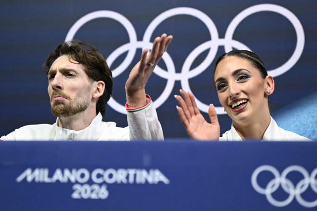Italy's Niccolo Macii and Italy's Sara Conti react in the kiss and cry area after competing in the figure skating pair skating free skating final during the Milano Cortina 2026 Winter Olympic Games at Milano Ice Skating Arena in Milan on February 16, 2026. (Photo by Gabriel BOUYS / AFP)