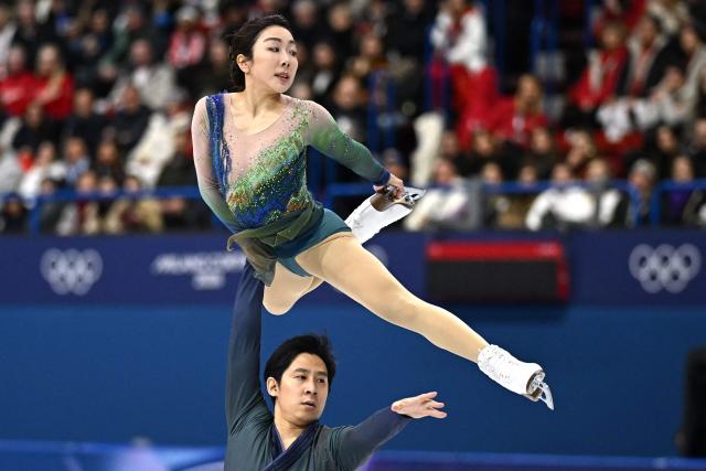 China's Sui Wenjing and China's Han Cong compete in the figure skating pair skating free skating final during the Milano Cortina 2026 Winter Olympic Games at Milano Ice Skating Arena in Milan on February 16, 2026. (Photo by Gabriel BOUYS / AFP)