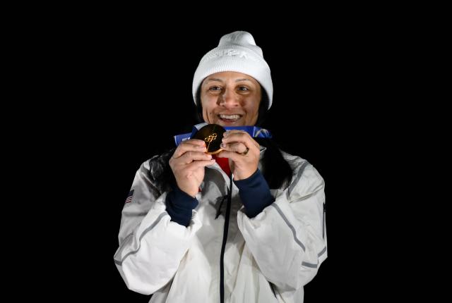 Gold medallist USA's Elana Meyers Taylor smiles on the podium of the bobsleigh women's monobob at Cortina Sliding Centre during the Milano Cortina 2026 Winter Olympic Games in Cortina d'Ampezzo on February 16, 2026. (Photo by Marco BERTORELLO / AFP)
