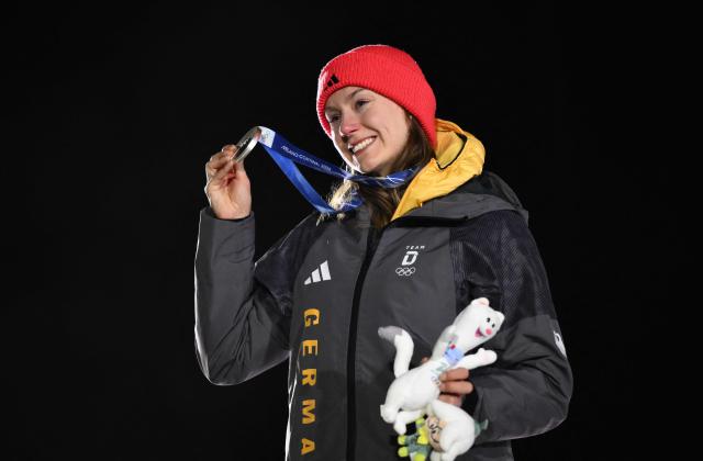 Silver medallist Germany's Laura Nolte poses on the podium of the bobsleigh women's monobob at Cortina Sliding Centre during the Milano Cortina 2026 Winter Olympic Games in Cortina d'Ampezzo on February 16, 2026. (Photo by Marco BERTORELLO / AFP)