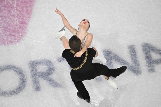 Canada's Lia Pereira and Canada's Trennt Michaud compete in the figure skating pair skating free skating final during the Milano Cortina 2026 Winter Olympic Games at Milano Ice Skating Arena in Milan on February 16, 2026. (Photo by Antonin THUILLIER / AFP)