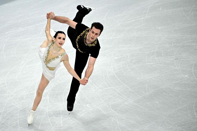 Canada's Lia Pereira and Trennt Michaud compete in the figure skating pair skating free skating final during the Milano Cortina 2026 Winter Olympic Games at Milano Ice Skating Arena in Milan on February 16, 2026. (Photo by JULIEN DE ROSA / AFP)