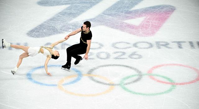 Canada's Lia Pereira and Trennt Michaud compete in the figure skating pair skating free skating final during the Milano Cortina 2026 Winter Olympic Games at Milano Ice Skating Arena in Milan on February 16, 2026. (Photo by JULIEN DE ROSA / AFP)
