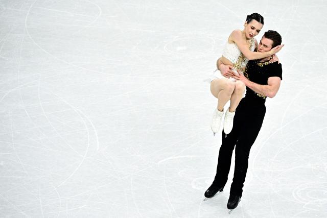 Canada's Lia Pereira and Trennt Michaud compete in the figure skating pair skating free skating final during the Milano Cortina 2026 Winter Olympic Games at Milano Ice Skating Arena in Milan on February 16, 2026. (Photo by JULIEN DE ROSA / AFP)