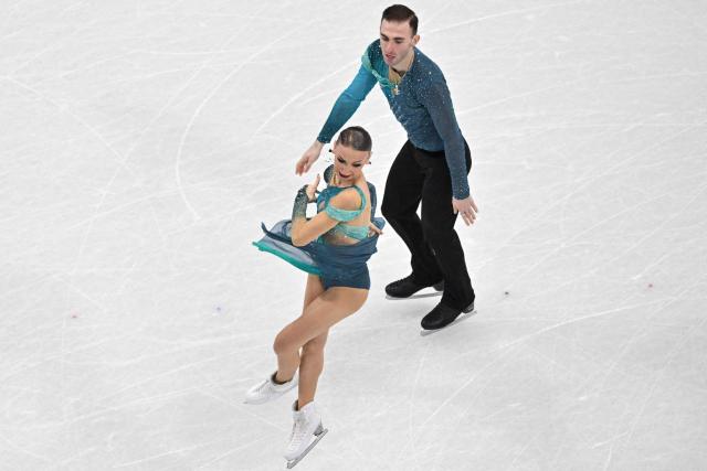 Georgia's Anastasiia Metelkina and Georgia's Luka Berulava compete in the figure skating pair skating free skating final during the Milano Cortina 2026 Winter Olympic Games at Milano Ice Skating Arena in Milan on February 16, 2026. (Photo by Antonin THUILLIER / AFP)