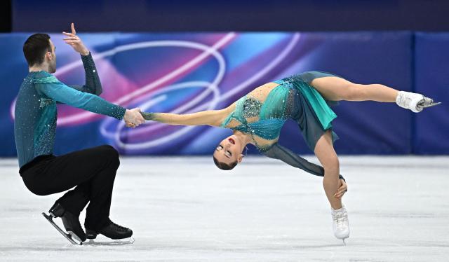 Georgia's Anastasiia Metelkina and Georgia's Luka Berulava compete in the figure skating pair skating free skating final during the Milano Cortina 2026 Winter Olympic Games at Milano Ice Skating Arena in Milan on February 16, 2026. (Photo by Gabriel BOUYS / AFP)
