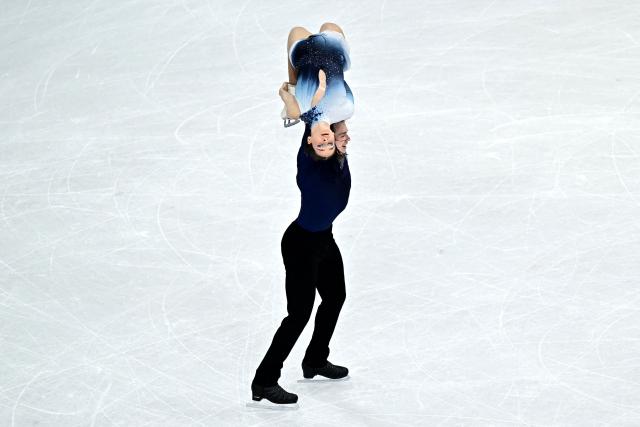 Hungary's Maria Pavlova and Alexsei Sviatchenko compete in the figure skating pair skating free skating final during the Milano Cortina 2026 Winter Olympic Games at Milano Ice Skating Arena in Milan on February 16, 2026. (Photo by JULIEN DE ROSA / AFP)