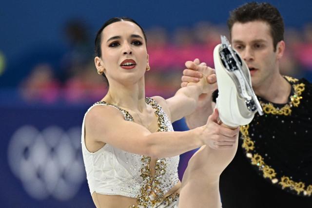 Canada's Lia Pereira and Canada's Trennt Michaud compete in the figure skating pair skating free skating final during the Milano Cortina 2026 Winter Olympic Games at Milano Ice Skating Arena in Milan on February 16, 2026. (Photo by Gabriel BOUYS / AFP)
