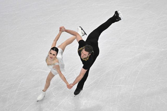 Canada's Lia Pereira and Canada's Trennt Michaud compete in the figure skating pair skating free skating final during the Milano Cortina 2026 Winter Olympic Games at Milano Ice Skating Arena in Milan on February 16, 2026. (Photo by Antonin THUILLIER / AFP)