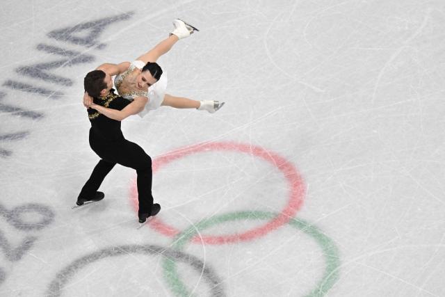 Canada's Lia Pereira and Canada's Trennt Michaud compete in the figure skating pair skating free skating final during the Milano Cortina 2026 Winter Olympic Games at Milano Ice Skating Arena in Milan on February 16, 2026. (Photo by Antonin THUILLIER / AFP)