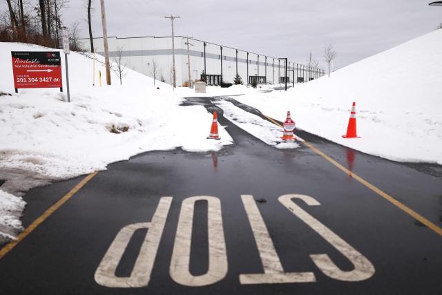 People protest against the planned project of converting a warehouse into a US Immigration and Customs Enforcement (ICE) detention center in Roxbury, New Jersey, on February 16, 2026. Activists say the Department of Homeland Security is considering converting this industrial warehouse into a US Immigration and Customs Enforcement (ICE) detention center which faces the opposition of the local community. (Photo by CHARLY TRIBALLEAU / AFP)
