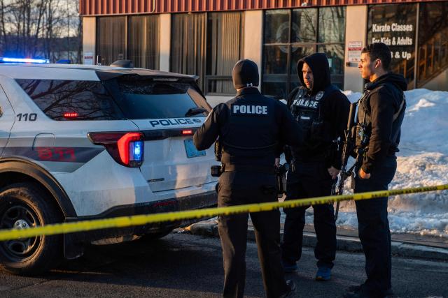 Police stand outside the perimeter they created around the Dennis M Lynch Arena where a shooting occurred earlier today in Pawtucket, Rhode Island, on February 16, 2026. At least two people were killed and three wounded in a shooting at an ice rink in the northeastern US town of Pawtucket on Monday, authorities said, with social media footage showing frightened teenagers fleeing the sound of gunshots. "We have three deceased. The suspect, and then we have two victims, and then we have three at the hospital," said Pawtucket police chief Tina Goncalves told reporters after the incident. She added that initial investigations suggested the shooting was targeted and "may be a family dispute." (Photo by Joseph Prezioso / AFP)